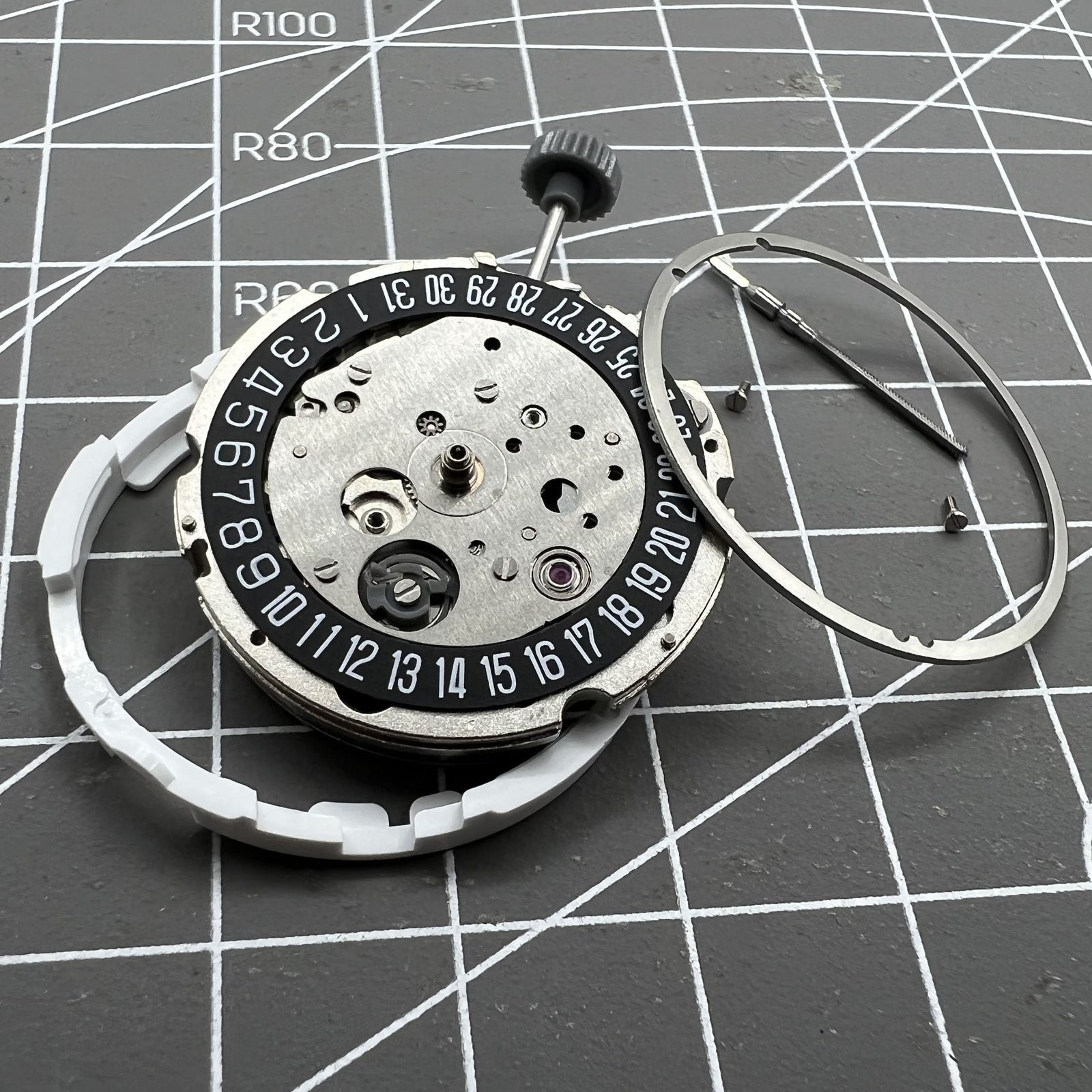 Miyota/Citizen 8215 watch movement with black dial and date at 6, automatic mechanical for precision timekeeping.