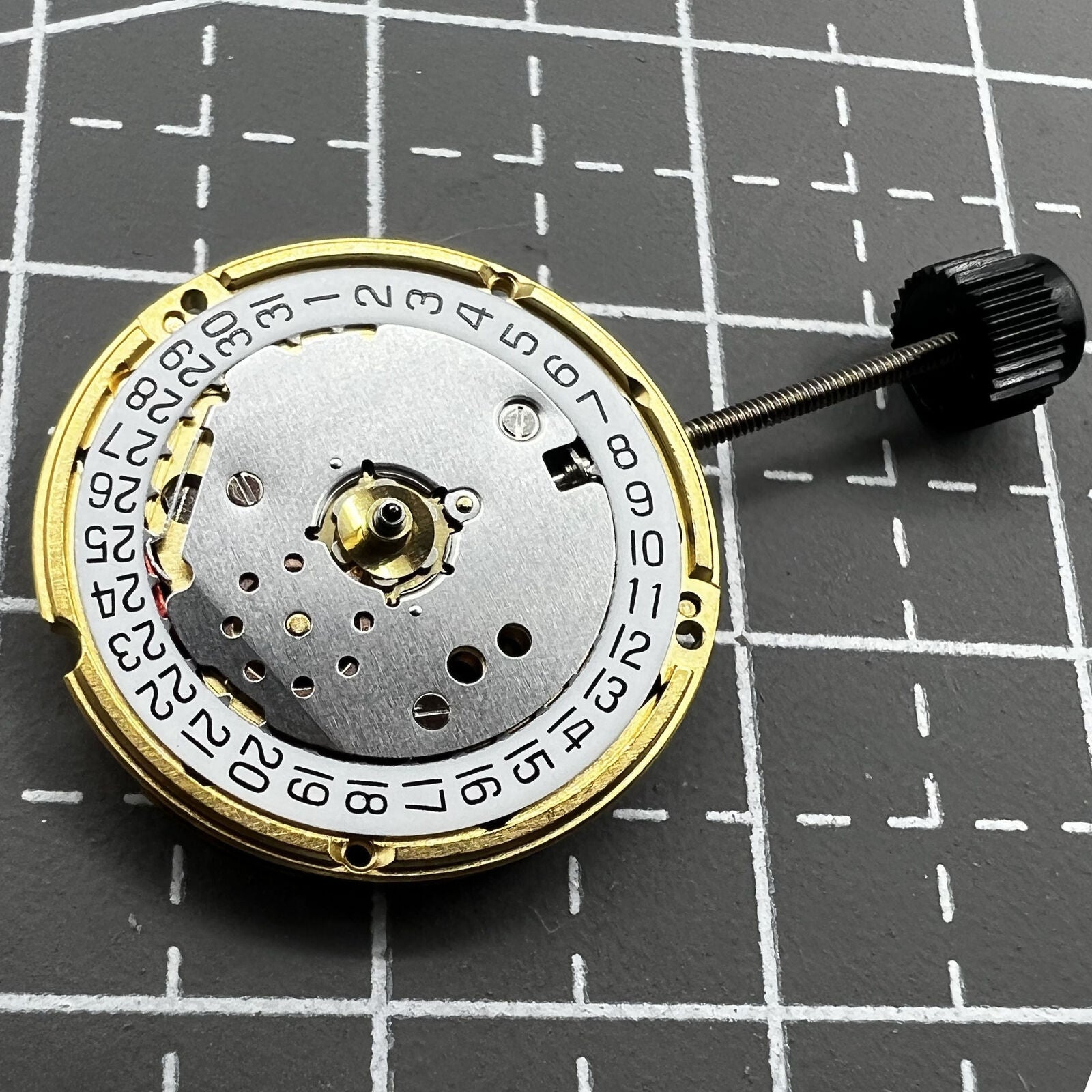 ETA F03.115 quartz movement with date window at 3 o'clock, precise three-hand watch component by ETA.