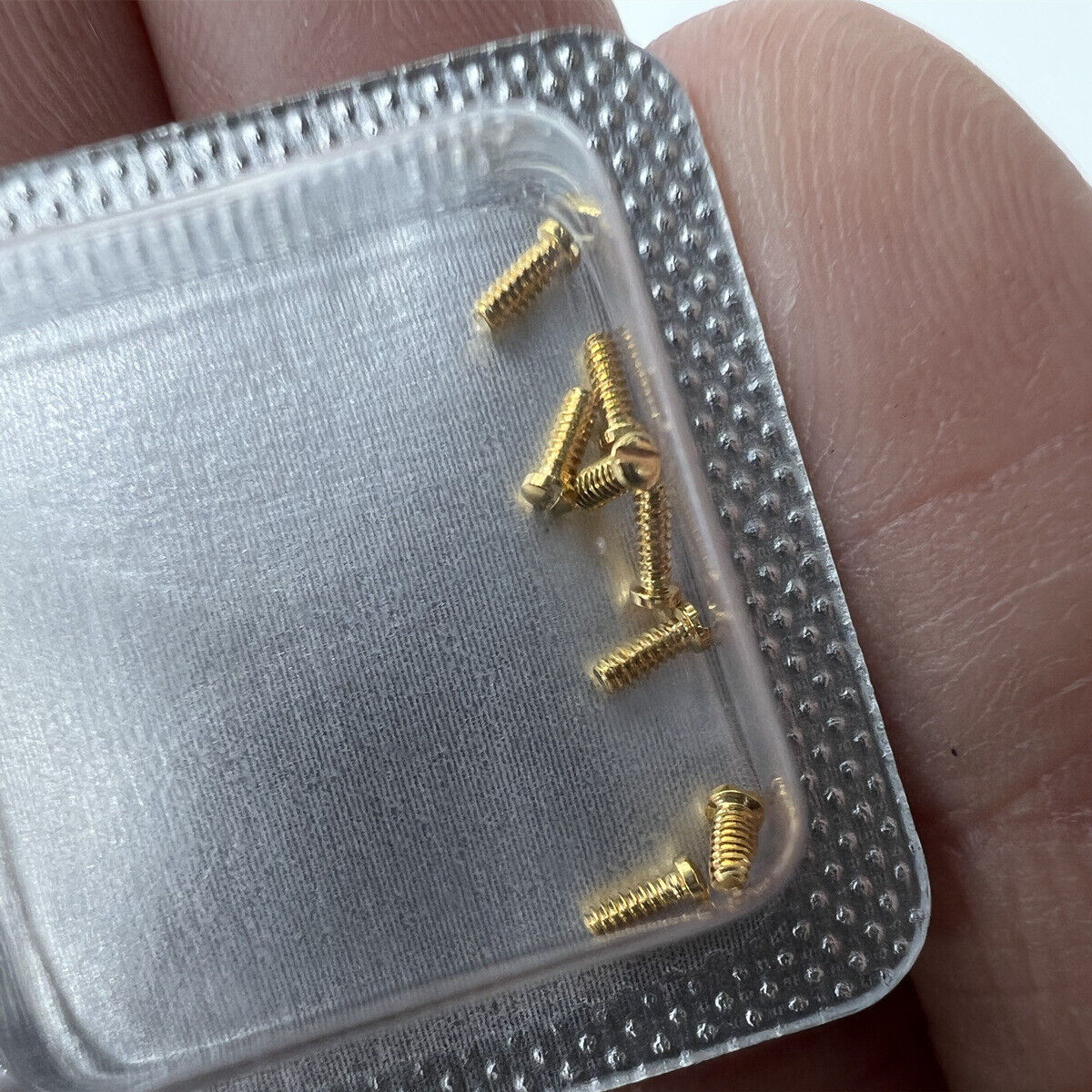 Golden 3x1mm slotted back cover screws for Cartier men's watches, durable and precise accessories.