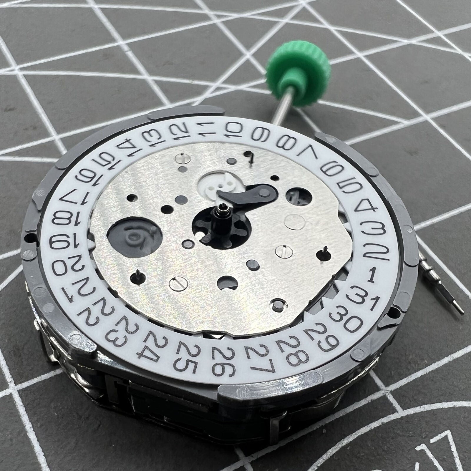 Miyota FS61 quartz chronograph watch movement with date at 4, three subdials, precise timekeeping, branded mechanism.