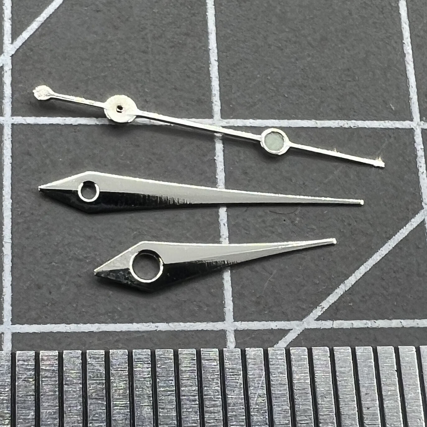Silver 13mm arrow-shaped watch hands set by Trim for Ronda 515 quartz movement watches.