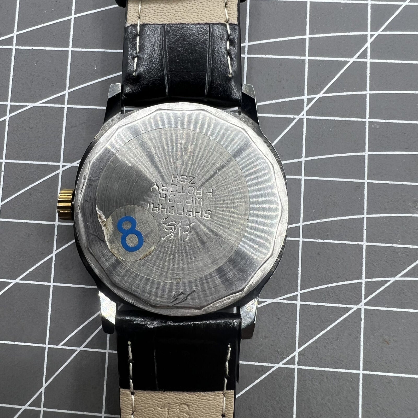 Shanghai Factory 34mm manual watch with black dial, 19 jewels, shock-resistant for durable timekeeping.