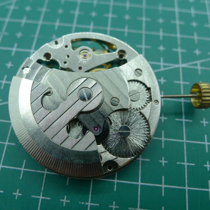 Silver automatic mechanical watch featuring hollow moon phase at 12 o'clock, elegant timepiece design.