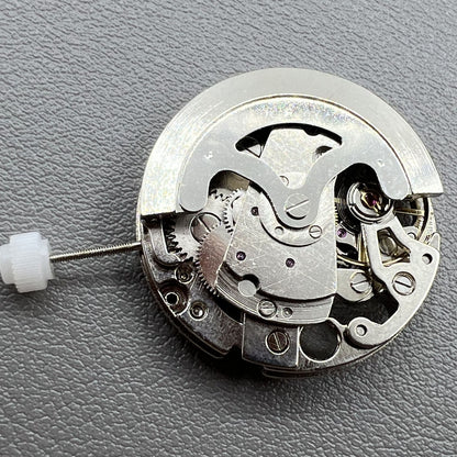 7120 Hollow silver automatic watch movement with visible mechanical gears and precision craftsmanship.