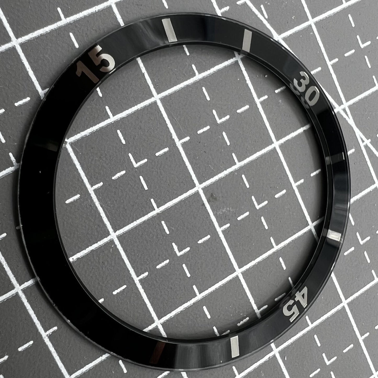 36mm black ceramic bezel insert with white numerals for men's and women's watches.