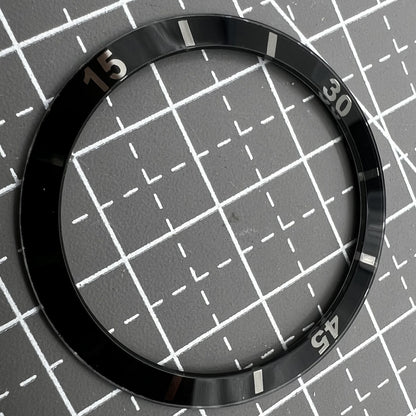 36mm black ceramic bezel insert with white numerals for men's and women's watches.