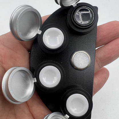 Die-cast alloy oil cup stand with 4 black ceramic containers for organized watch accessory storage.