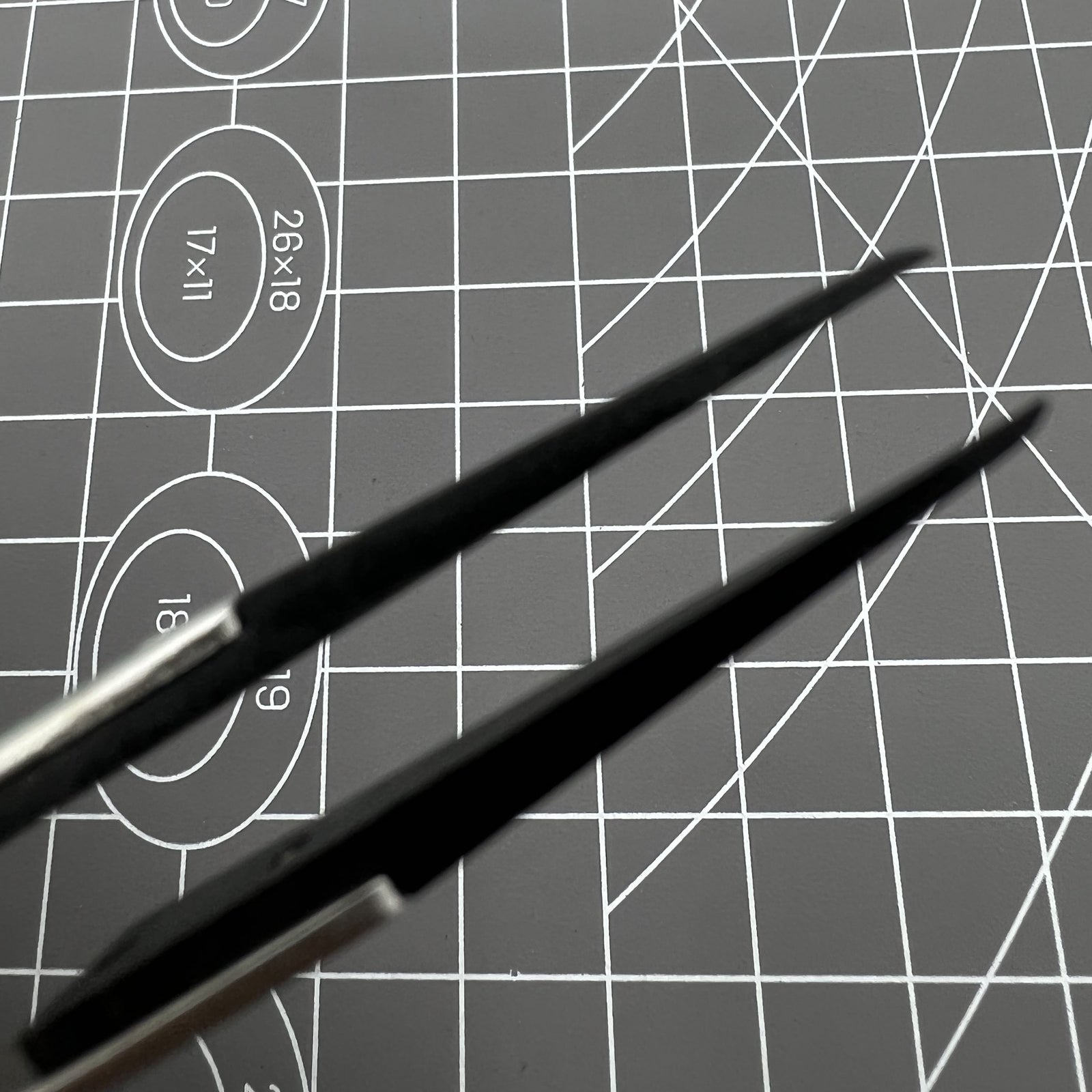 Stainless steel carbon fiber tweezers for precise watch repair and delicate accessory handling.