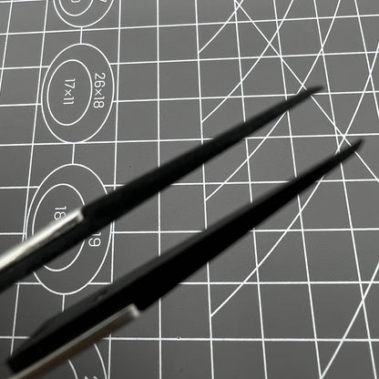 Stainless steel carbon fiber tweezers for precise watch repair and delicate accessory handling.