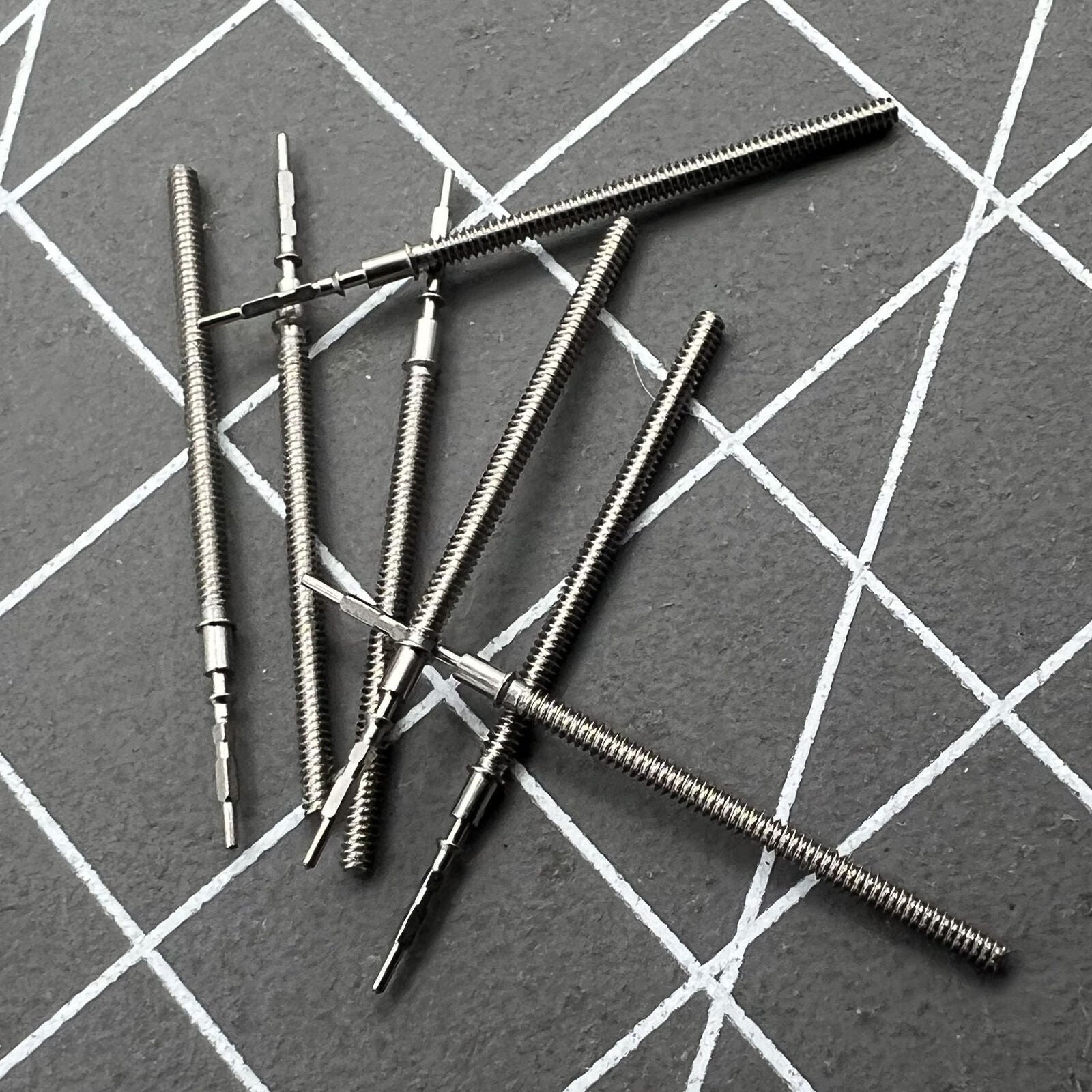 Watch winding stem for VX12E movement, spare part, ideal for precise watch repair.