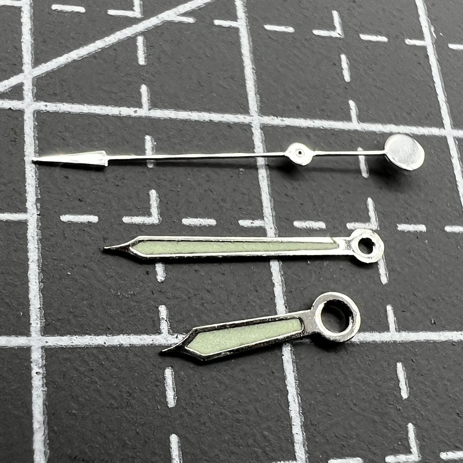 Green luminous watch hands with silver trim for Miyota 2035-2315 movements, perfect for precision repairs.