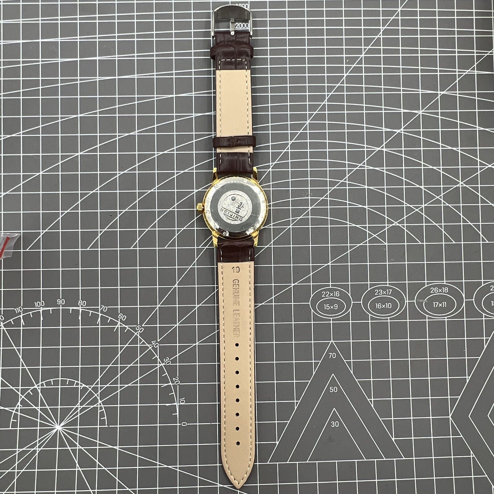Beijing Double Rhomb mechanical watch with golden case and silver nail markers, elegant classic style for formal wear.