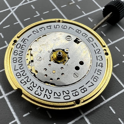 ETA F04.111 quartz watch movement showing three hands and date window, Swiss precision craftsmanship by ETA.