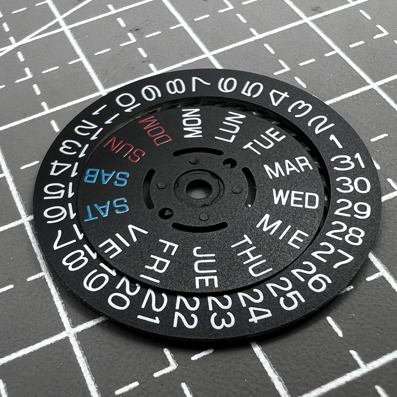 Black watch accessory showing date and day wheel at 3 o'clock crown for Seiko NH36 movement.