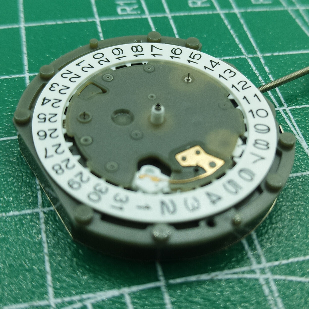 Sunon PE50 quartz watch movement showing date at 3 and small seconds at 2, 6, and 10 positions.