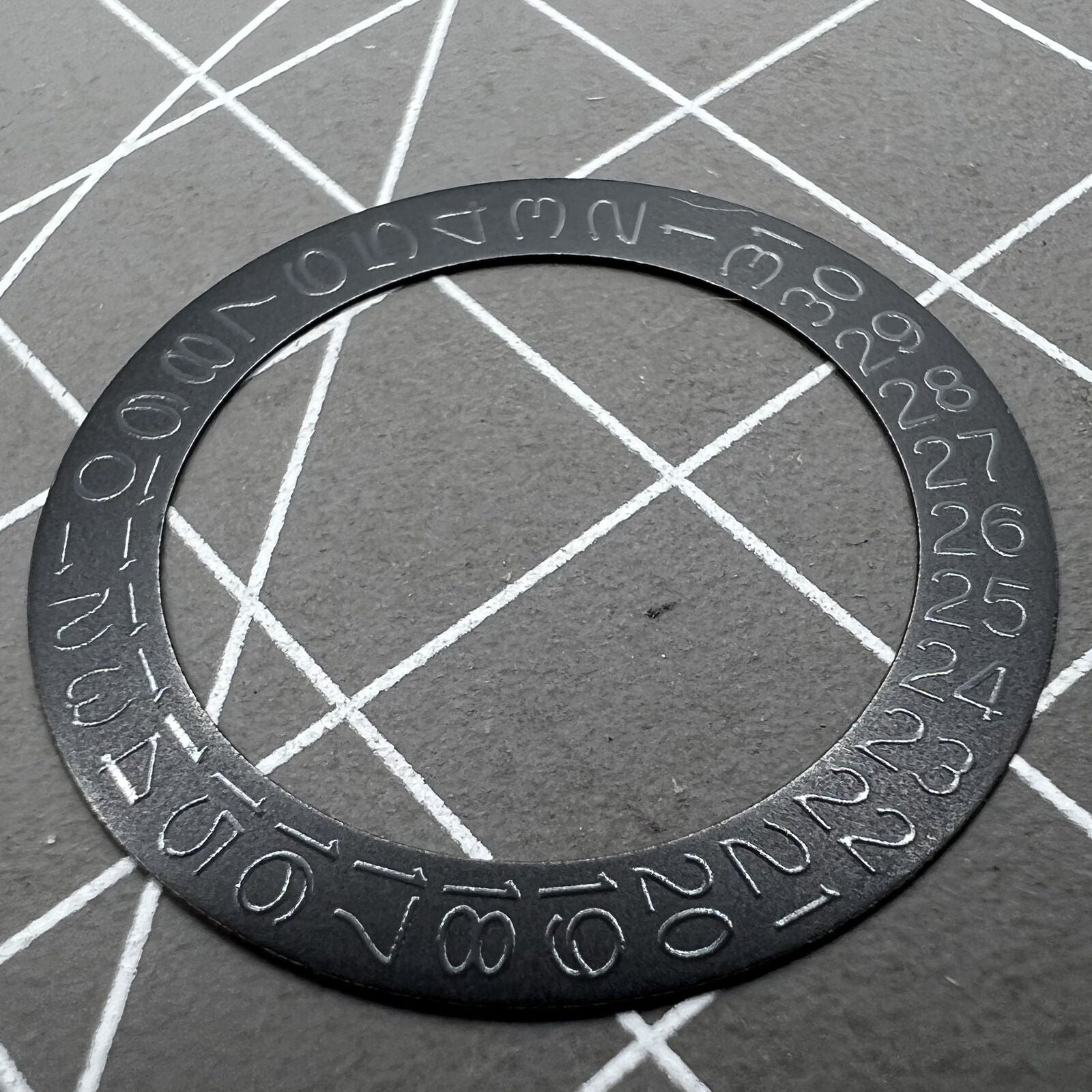 Black background close-up of Grey Character Date Disk for Seiko NH35 NH36 watch movement.