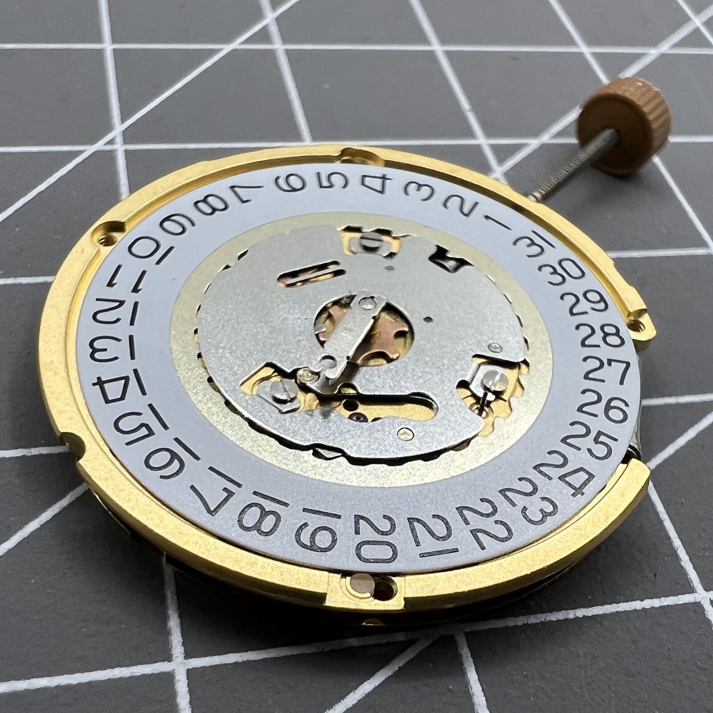 Swiss Made Ronda 6004D quartz watch movement with date window at 3 o?clock for precise timekeeping.
