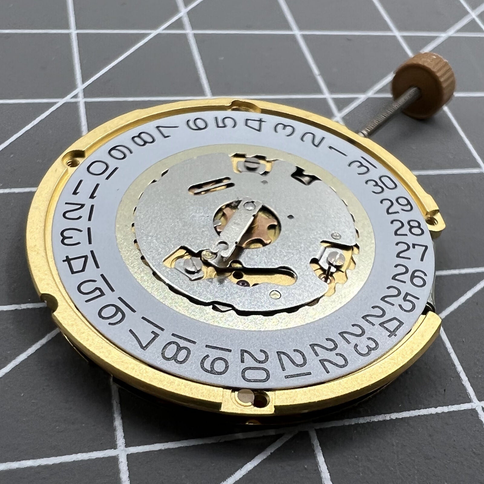 Swiss Made Ronda 6004D quartz watch movement with date window at 3 o?clock for precise timekeeping.