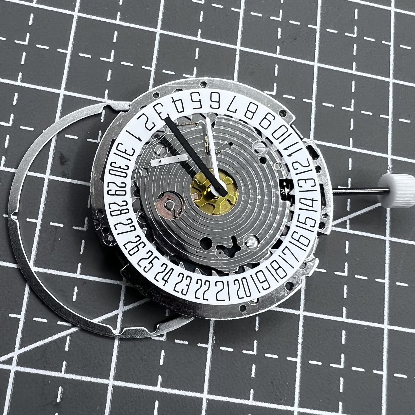 Swiss ISA 8171A quartz watch movement with white dial, four hands, and date at 6 o?clock for precise timekeeping.
