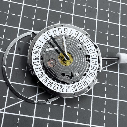 Swiss ISA 8171A quartz watch movement with white dial, four hands, and date at 6 o?clock for precise timekeeping.