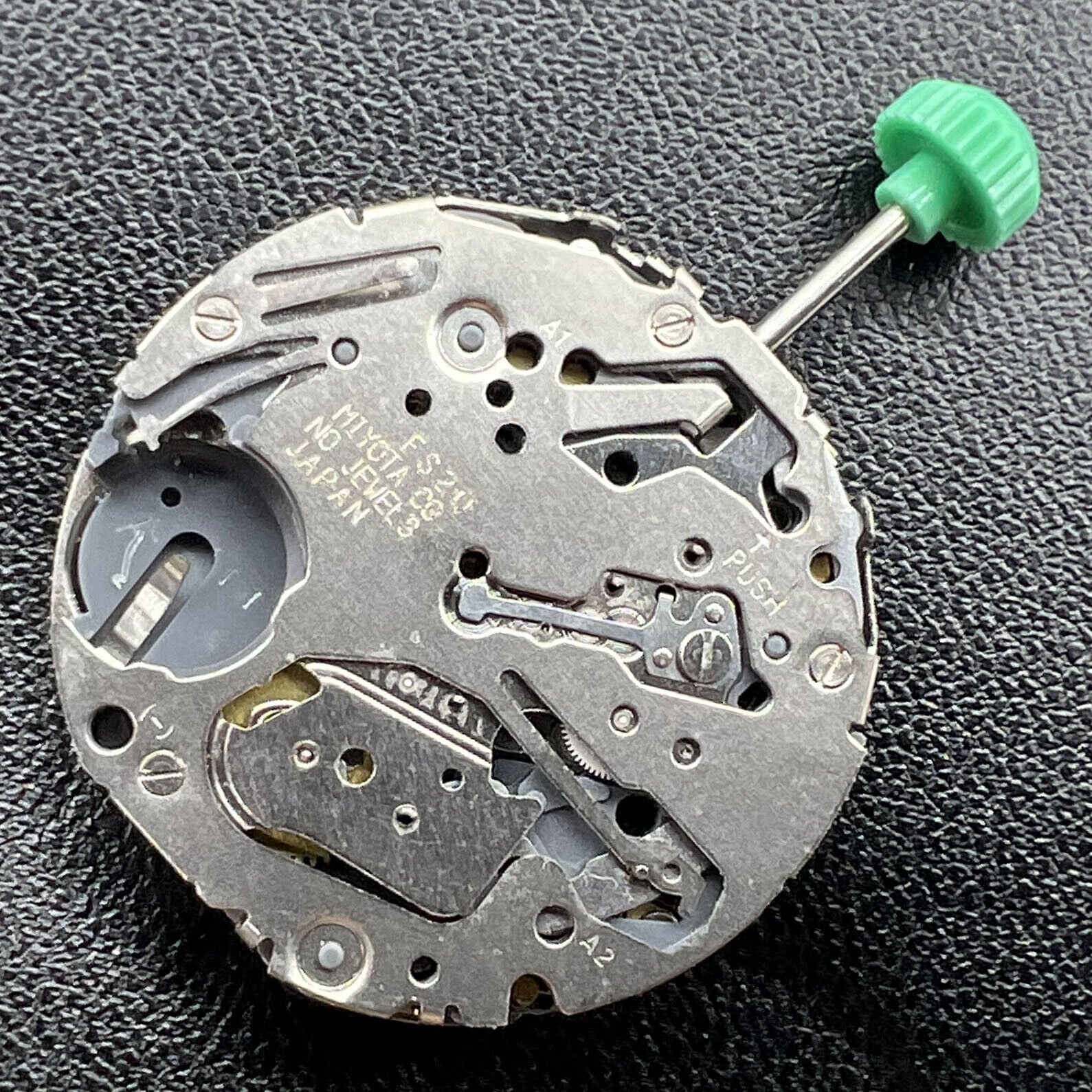 Miyota FS20 chronograph watch movement showing date at 3 o'clock, Japan quartz precision.