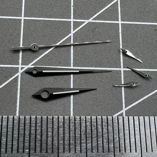 Polished black luminous watch hands set for Ronda 5040B quartz movement, enhancing readability.