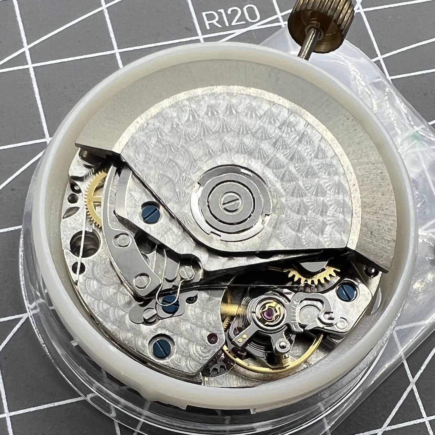 7750 mechanical watch movement featuring big date at 12 and small second at 3, showcasing precision craftsmanship.