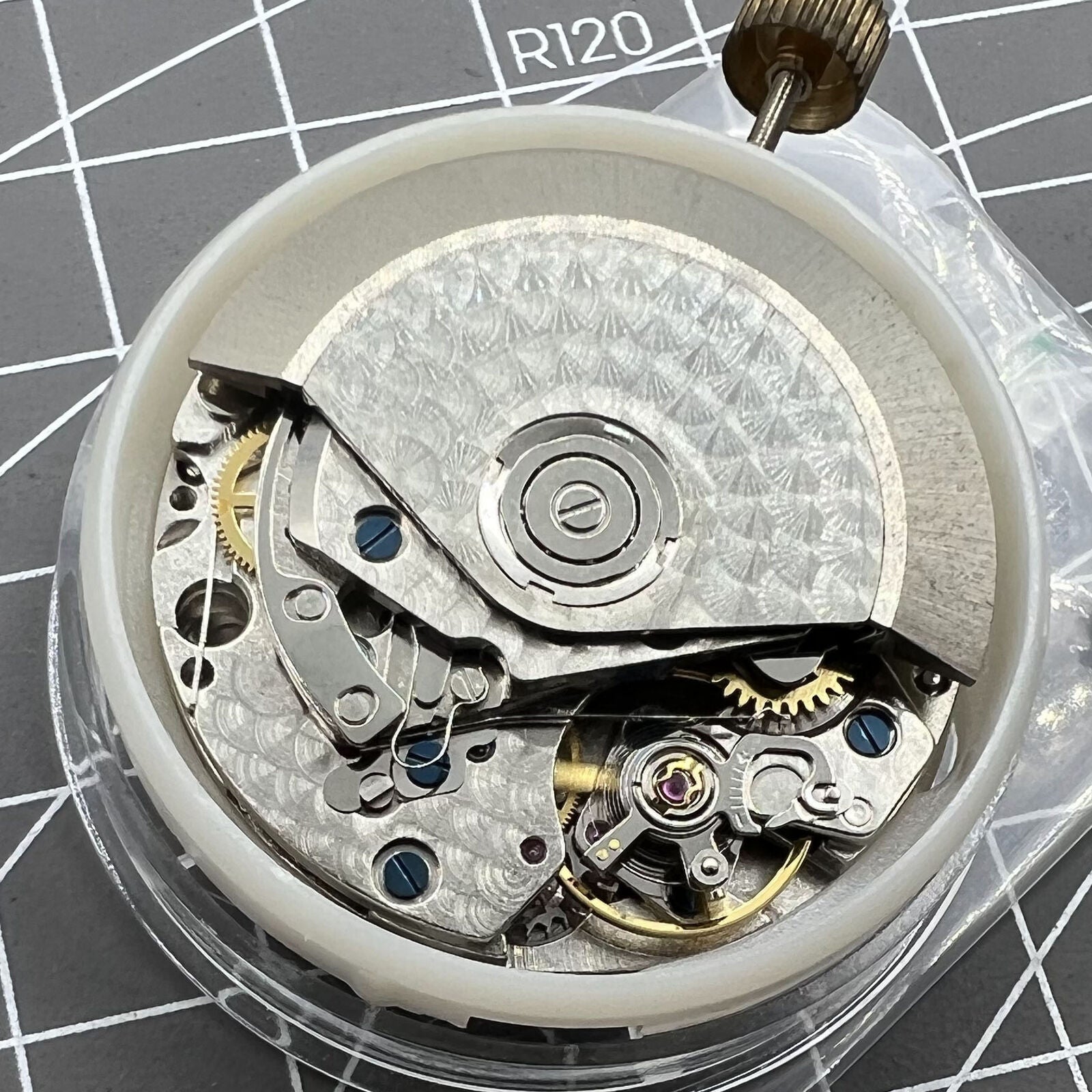7750 mechanical watch movement featuring big date at 12 and small second at 3, showcasing precision craftsmanship.