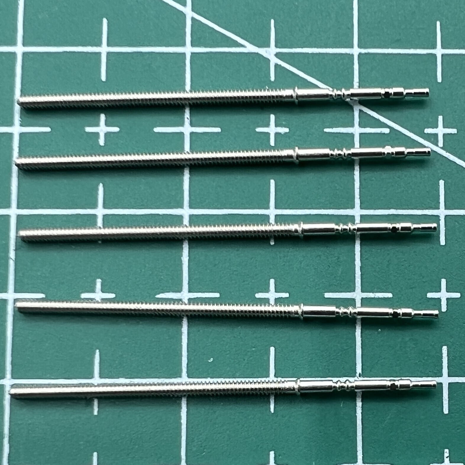 Wholesale lot of replacement watch winding stems compatible with PE90 movement, durable watch repair parts.