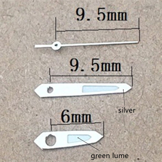 Silver trim arrow-shaped green lume watch hands for Miyota 1M12 movement, enhancing readability and style.
