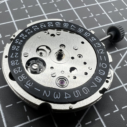 Citizen Miyota 8215 automatic mechanical watch movement with black dial and date display at 3 o'clock.