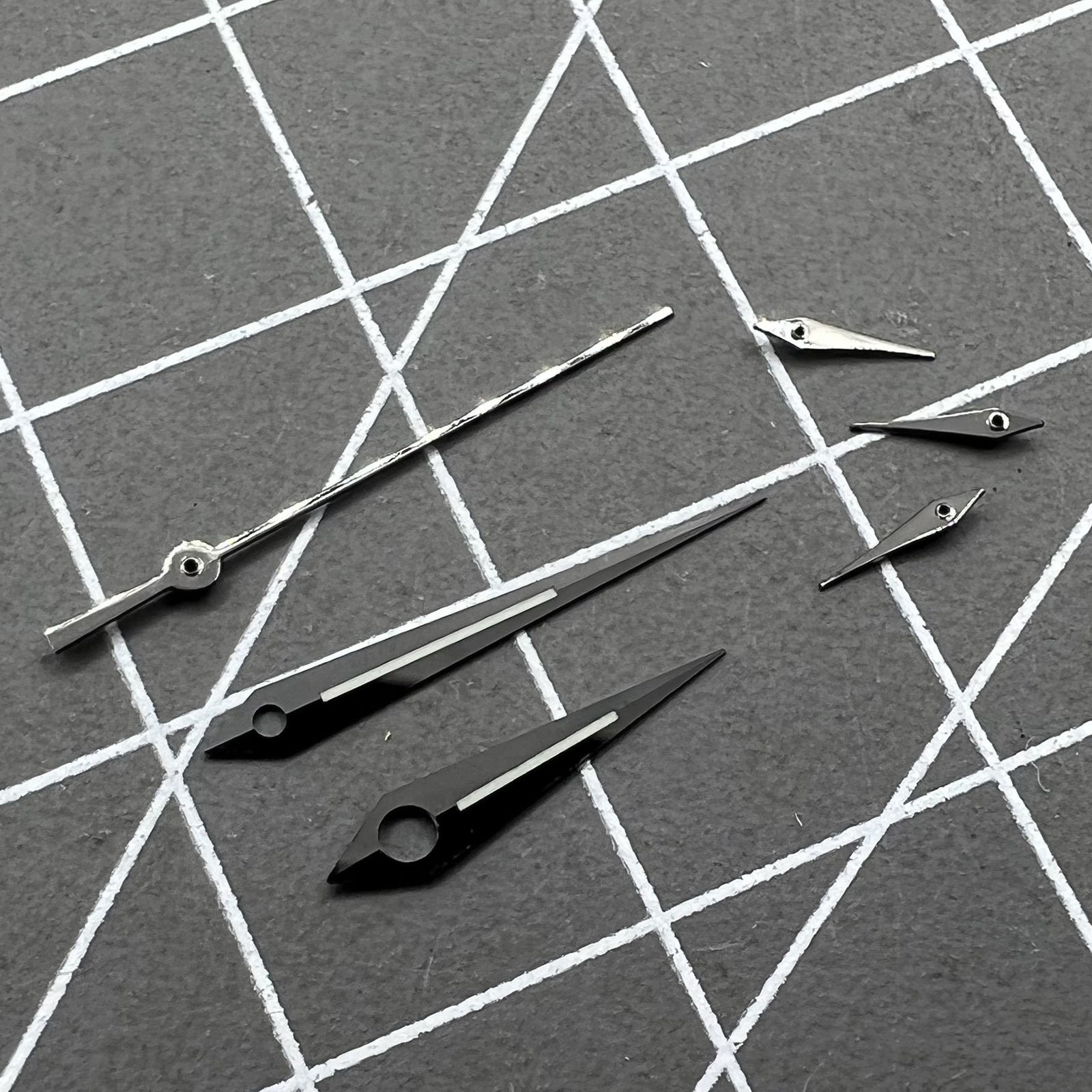 Polished black luminous watch hands set for Ronda 5040B quartz movement, enhancing readability.