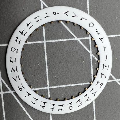 White background close-up of Arabic date disk wheel for ETA2824 Datejust watches, precision component.