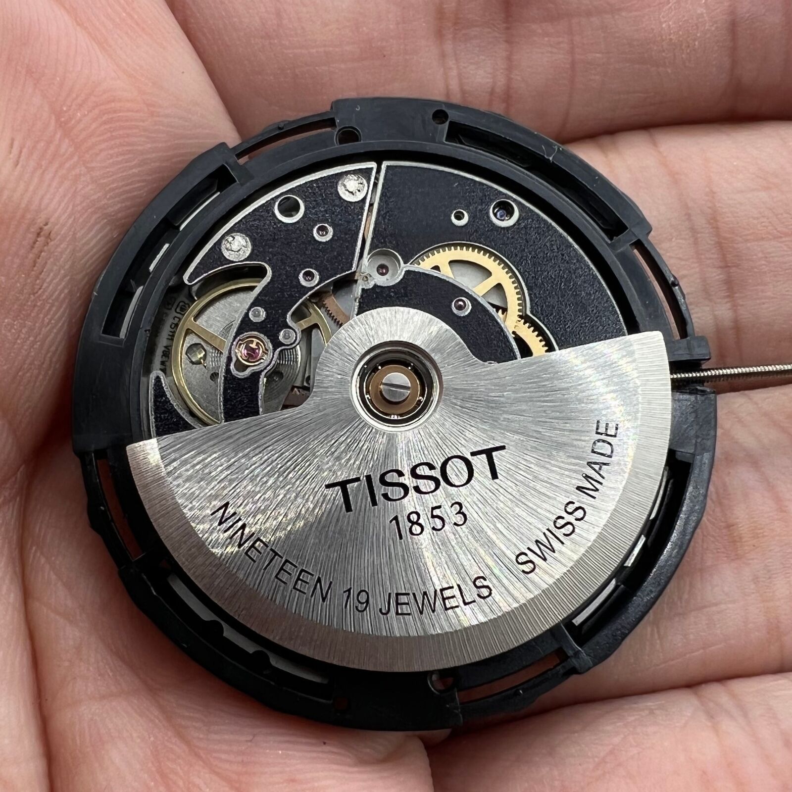 Tissot ETA C15.111 chronograph watch movement with white dial, Swiss precision craftsmanship.