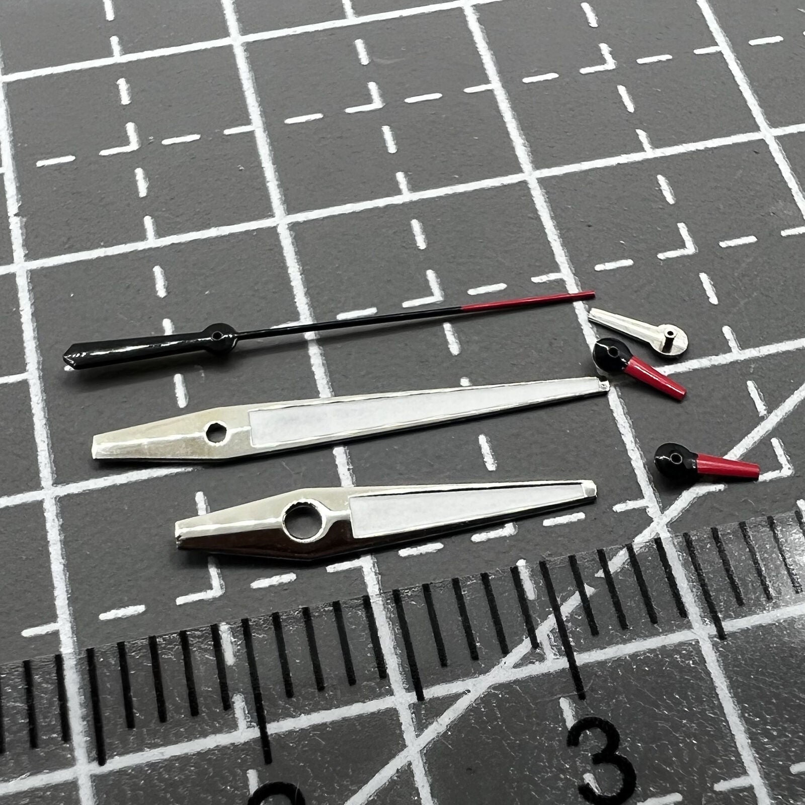 Red and white small second watch hands with silver trim for Miyota OS series, enhancing precision and style.