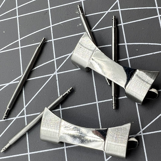Stainless steel curved end links with spring bars for secure watch band attachment.