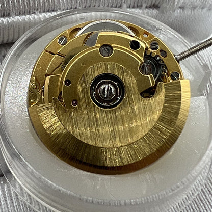 Golden ETA2671 mechanical watch movement with date display at 3 o'clock, precise replacement part.
