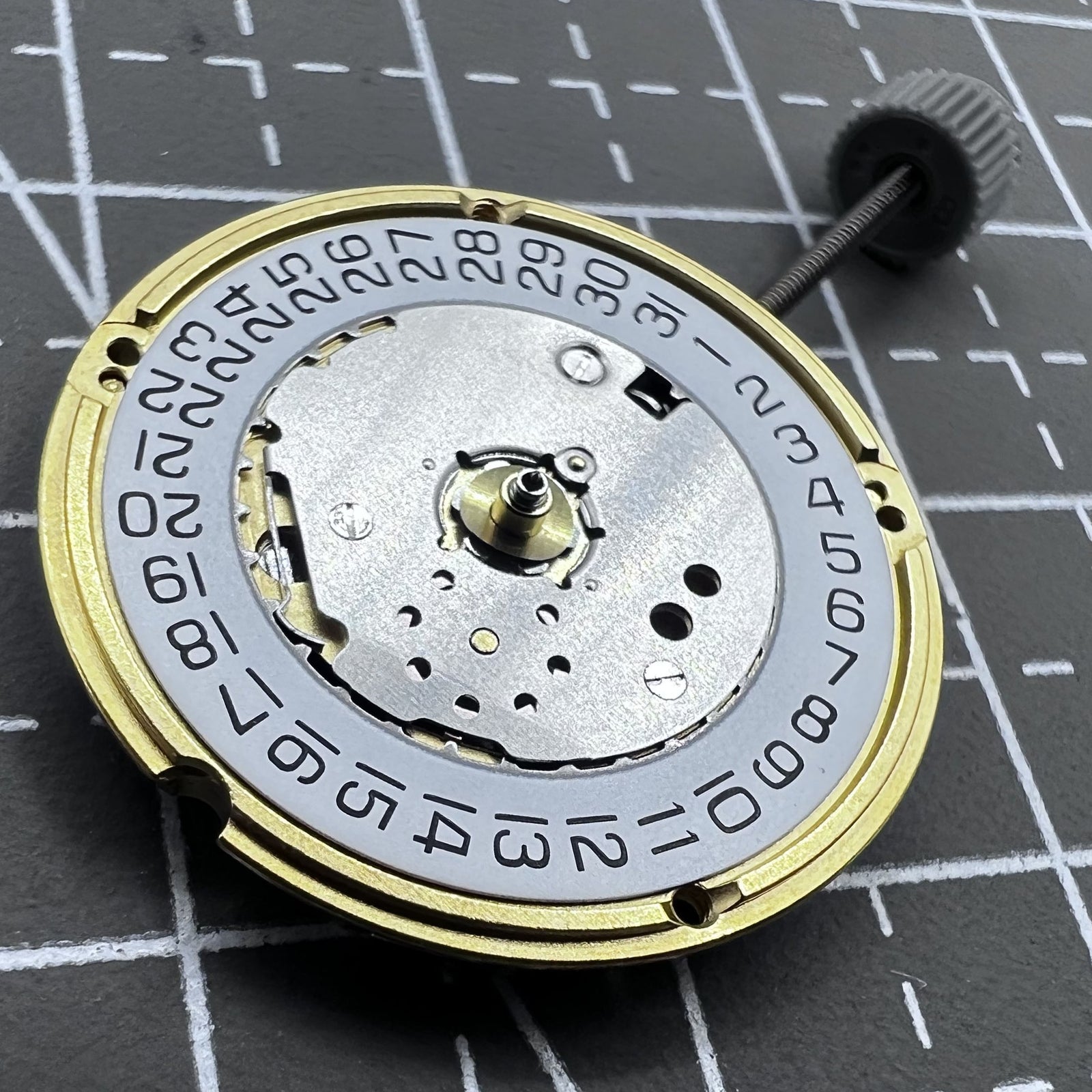 Swiss ETA F04.115 quartz watch movement with 3 hands and date display at 3 o'clock for precision timing.