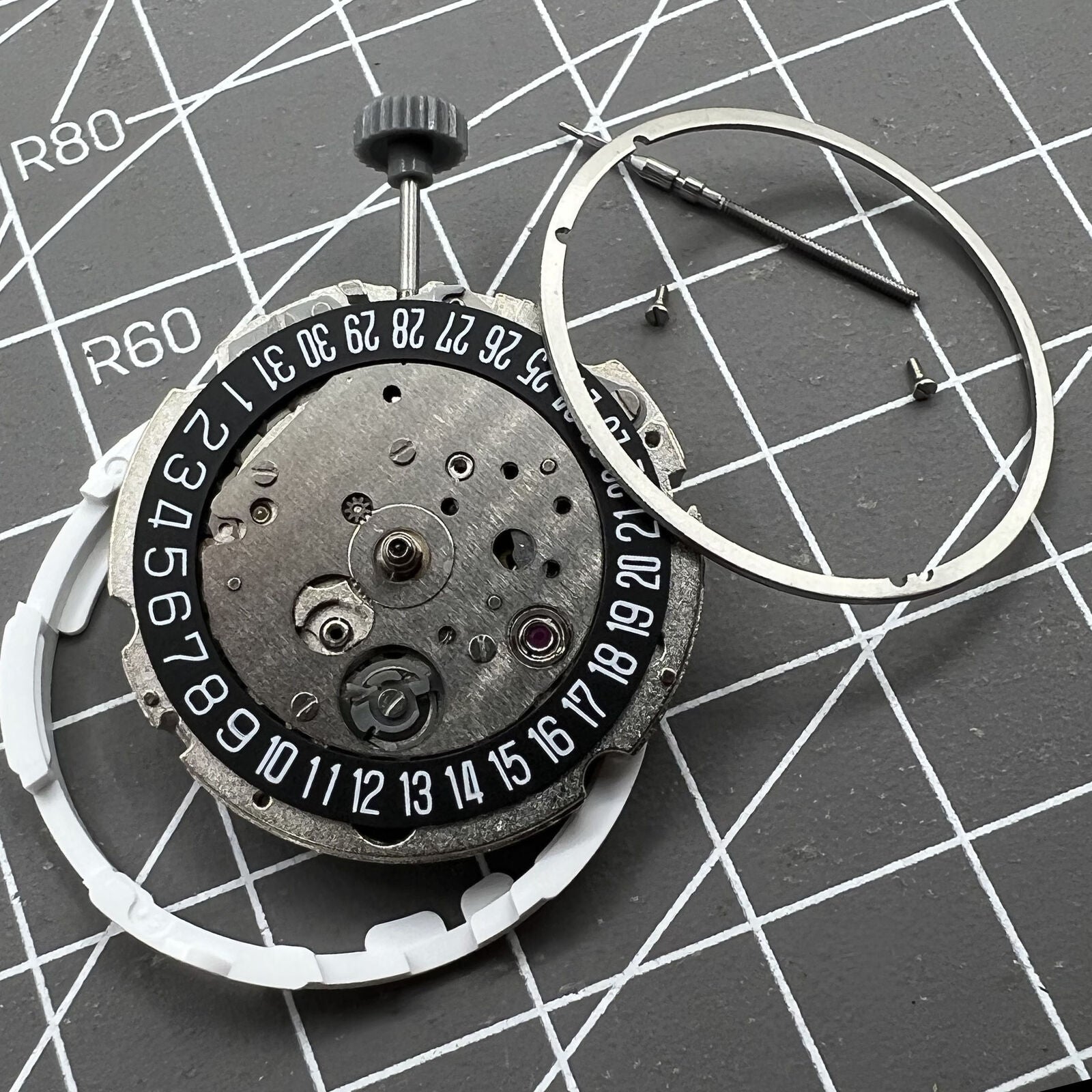 Miyota/Citizen 8215 watch movement with black dial and date at 6, automatic mechanical for precision timekeeping.