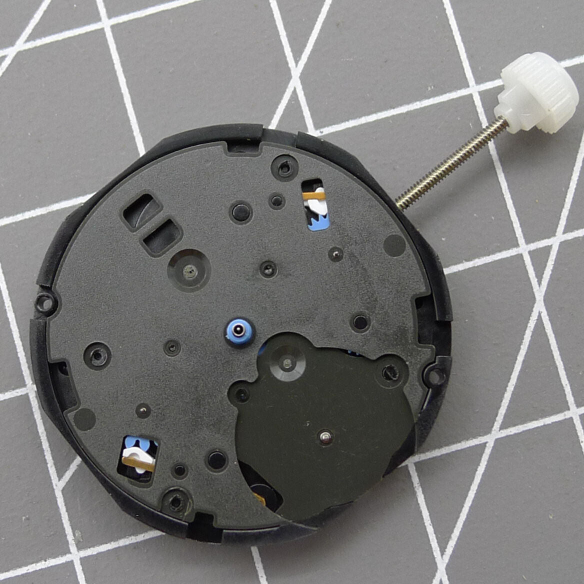 Sunon PE80 quartz watch movement showing three hands with small seconds at 3, 6, and 9 positions.