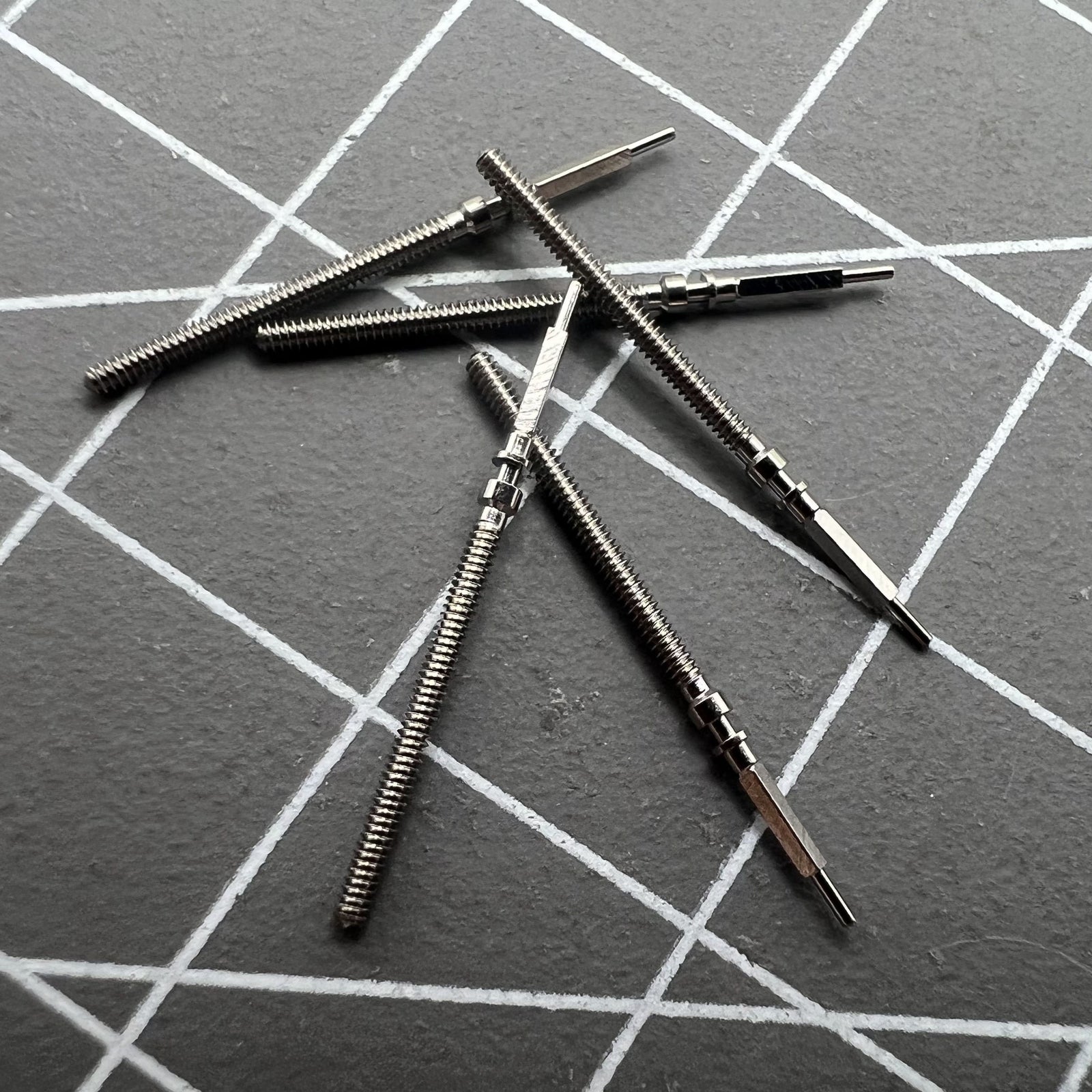 Set of 2 Omega winding stems for 560-565 watch movements, ideal for accurate watch repairs and replacements.