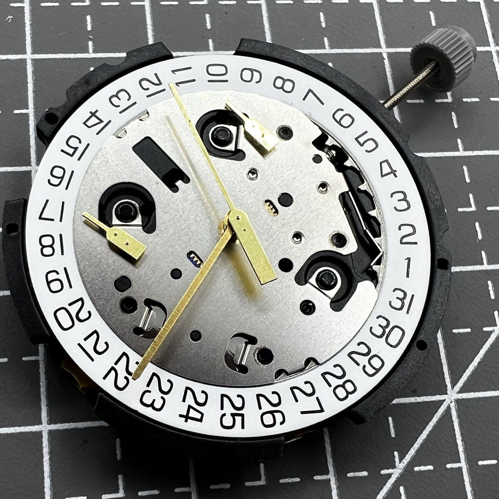 ETA G10.212 quartz watch movement with three hands and date display by ETA, precision timekeeping component.