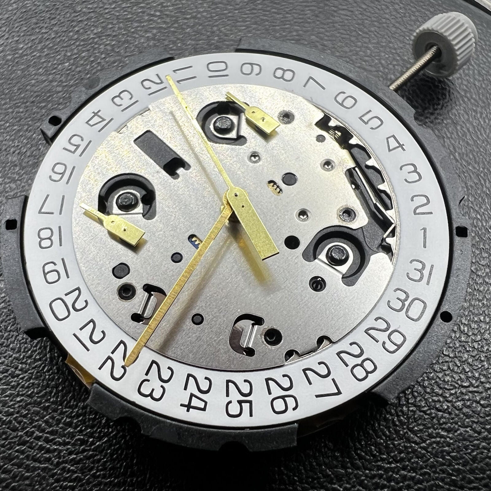 Swiss ETA G10.212 quartz watch movement with 3 hands and date display for precise timing mechanisms.