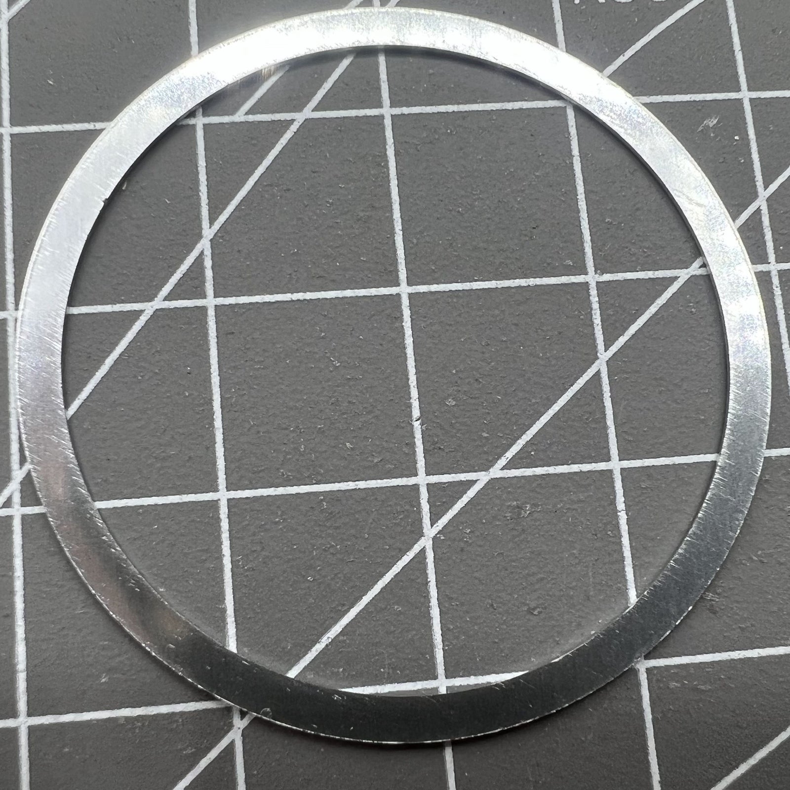 38.5mm Omega Speedmaster bezel in aluminum alloy with white ring and black font for watch customization.