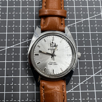 PUBU 32mm manual mechanical watch with grey dial, nail markers, 17 jewels, showcasing precision craftsmanship.