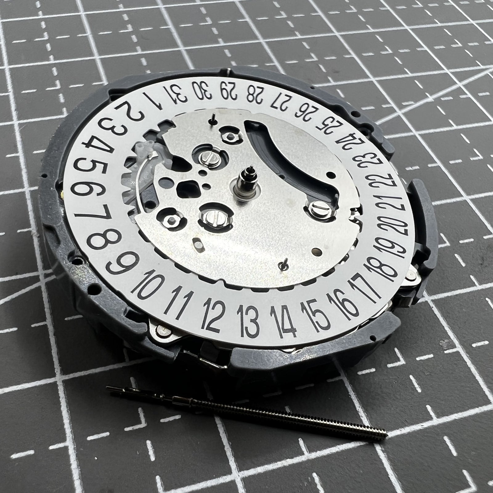 Japan Hattori VK64A quartz watch movement with date at 6 o'clock for precise timekeeping.