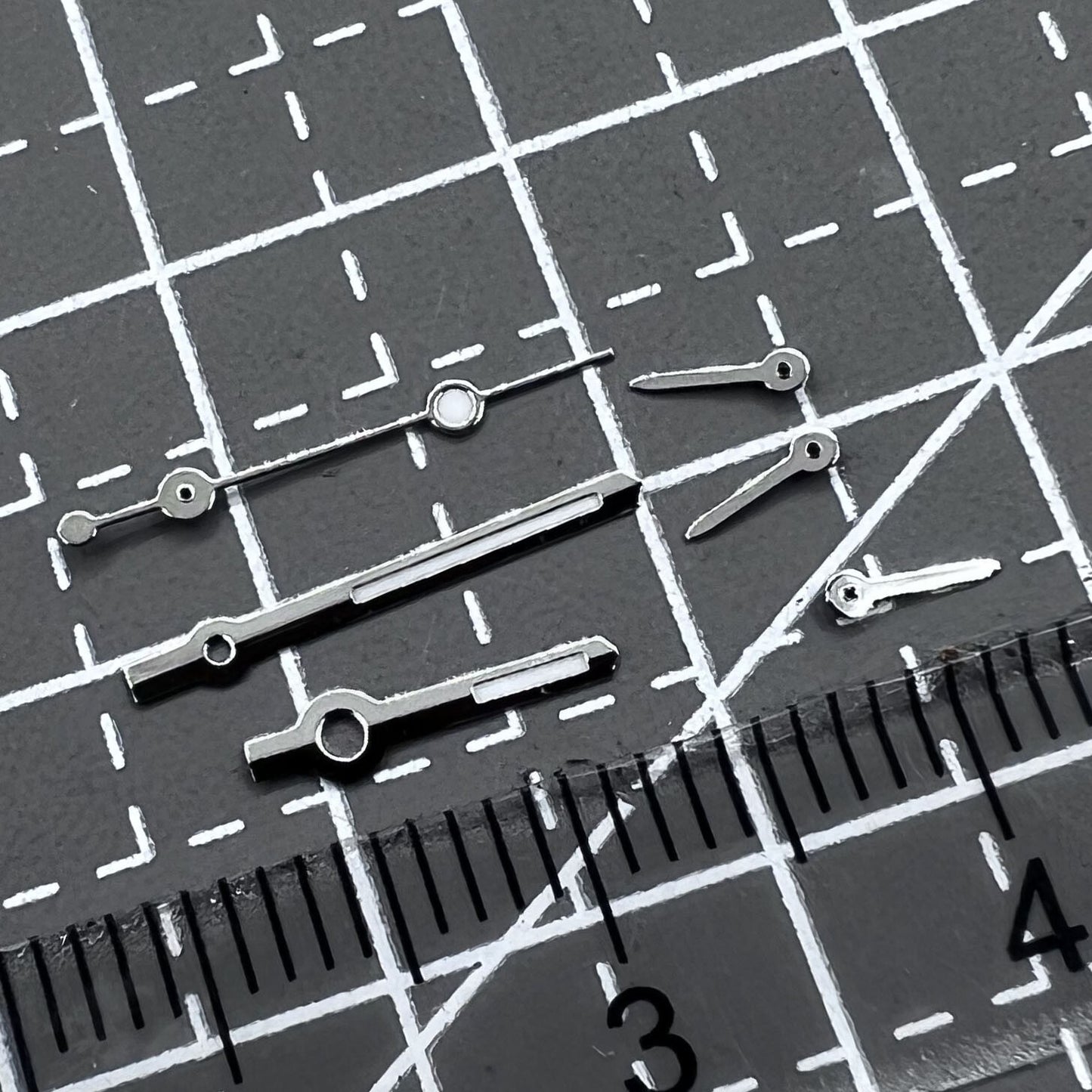 Silver arrow-shaped watch hands with green luminous trim, compatible with VD53 VD54 VD57 movements, 2 sets per pack.