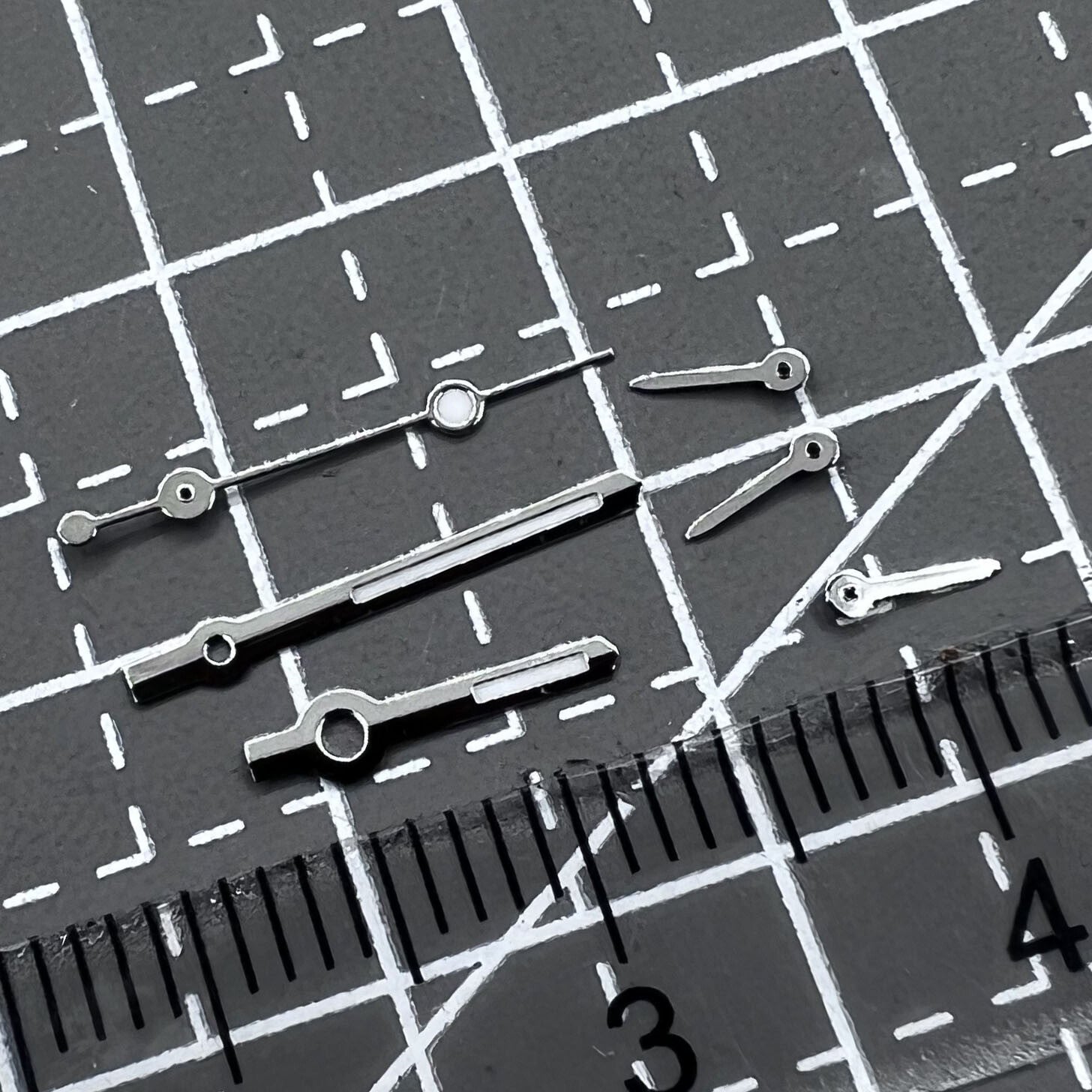 Silver arrow-shaped watch hands with green luminous trim, compatible with VD53 VD54 VD57 movements, 2 sets per pack.