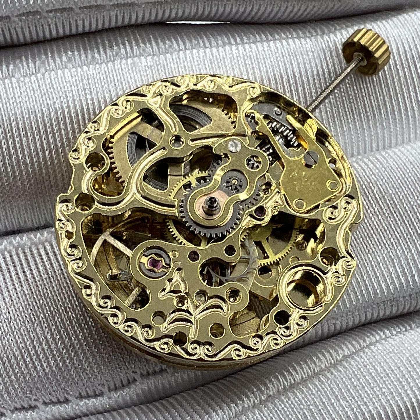 Golden 26.5mm 7120 automatic mechanical watch movement with intricate carved hollow design for luxury watchmaking.