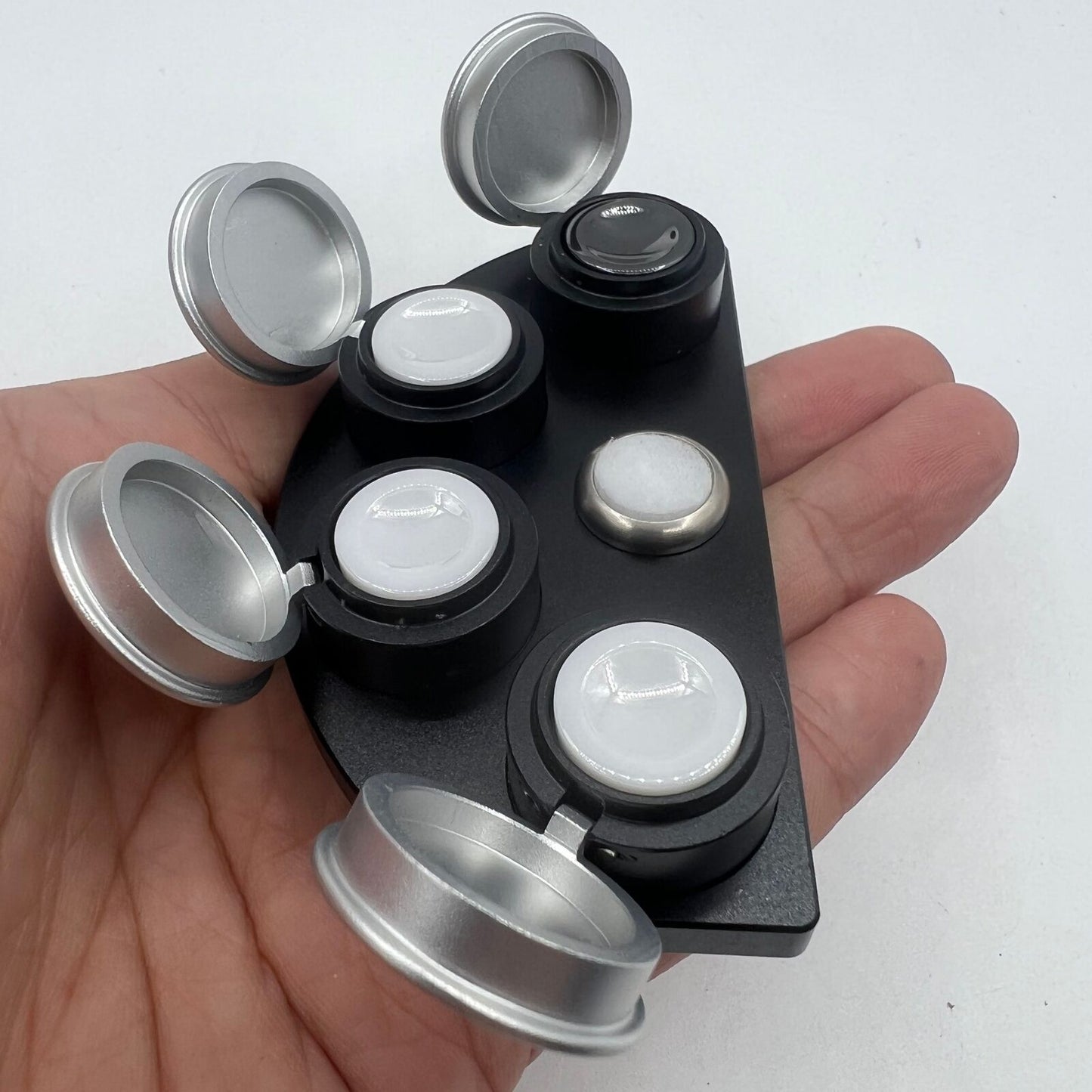 Die-cast alloy oil cup stand with 4 black ceramic containers for watch accessory storage.